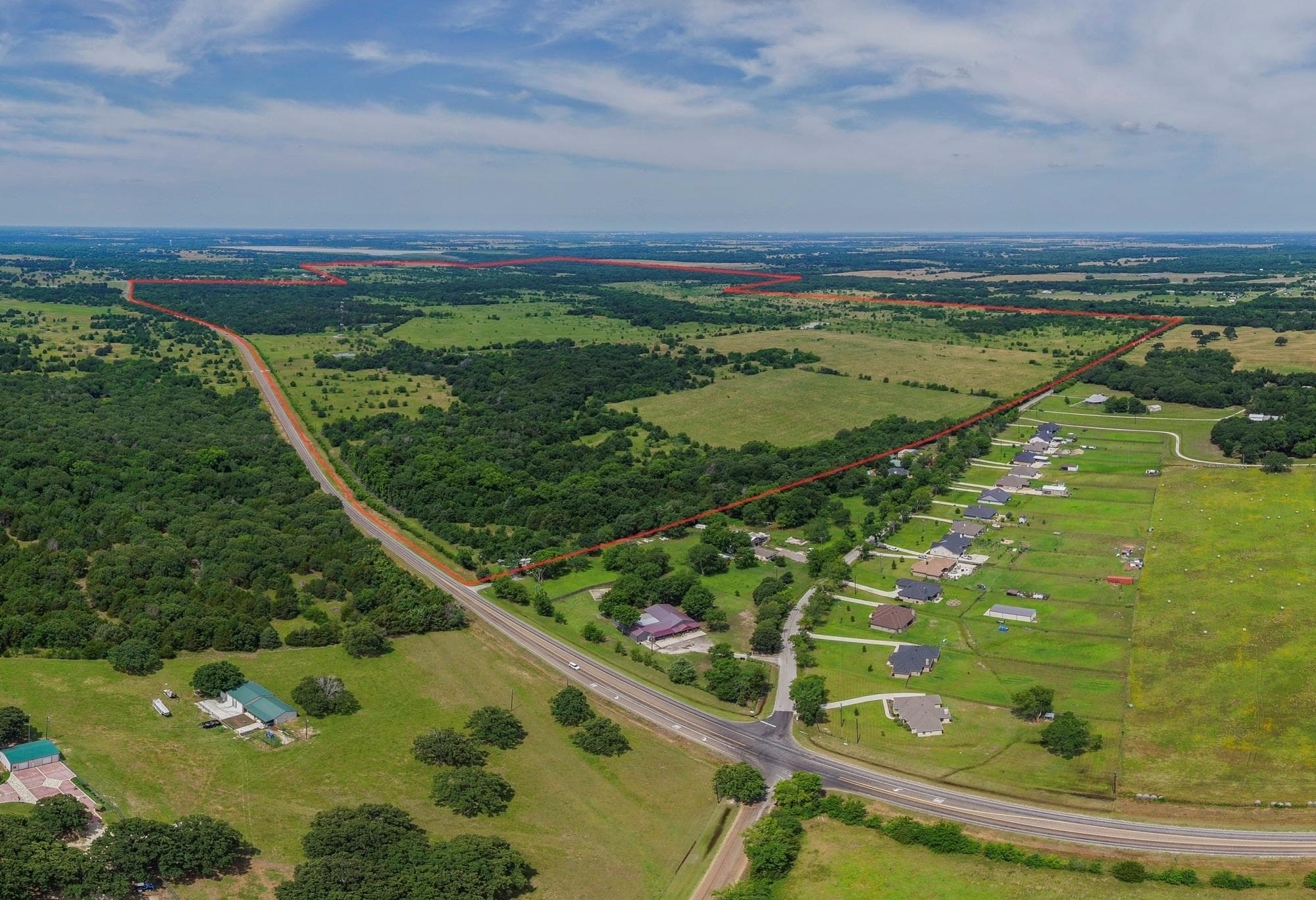 Aerial view of one of our land listings with pasture and trees